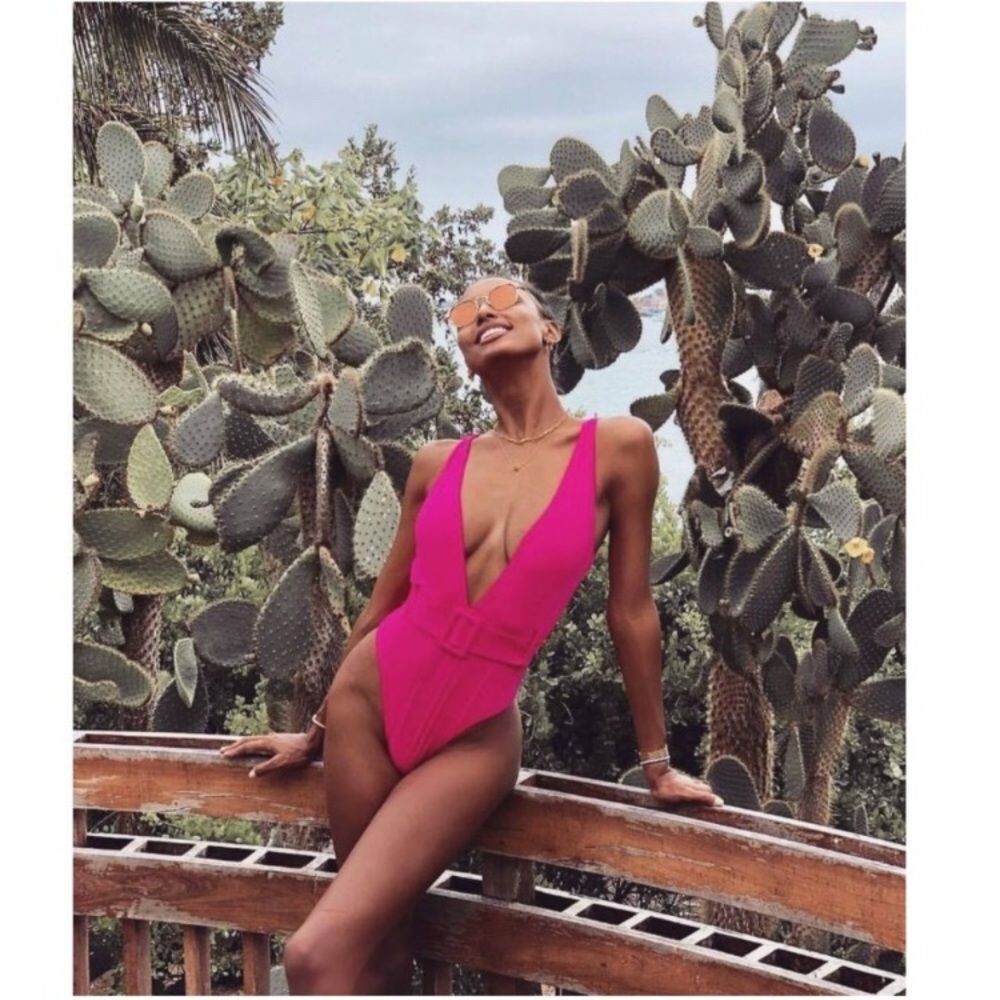 Pink one piece swim suit. With faux belted waist